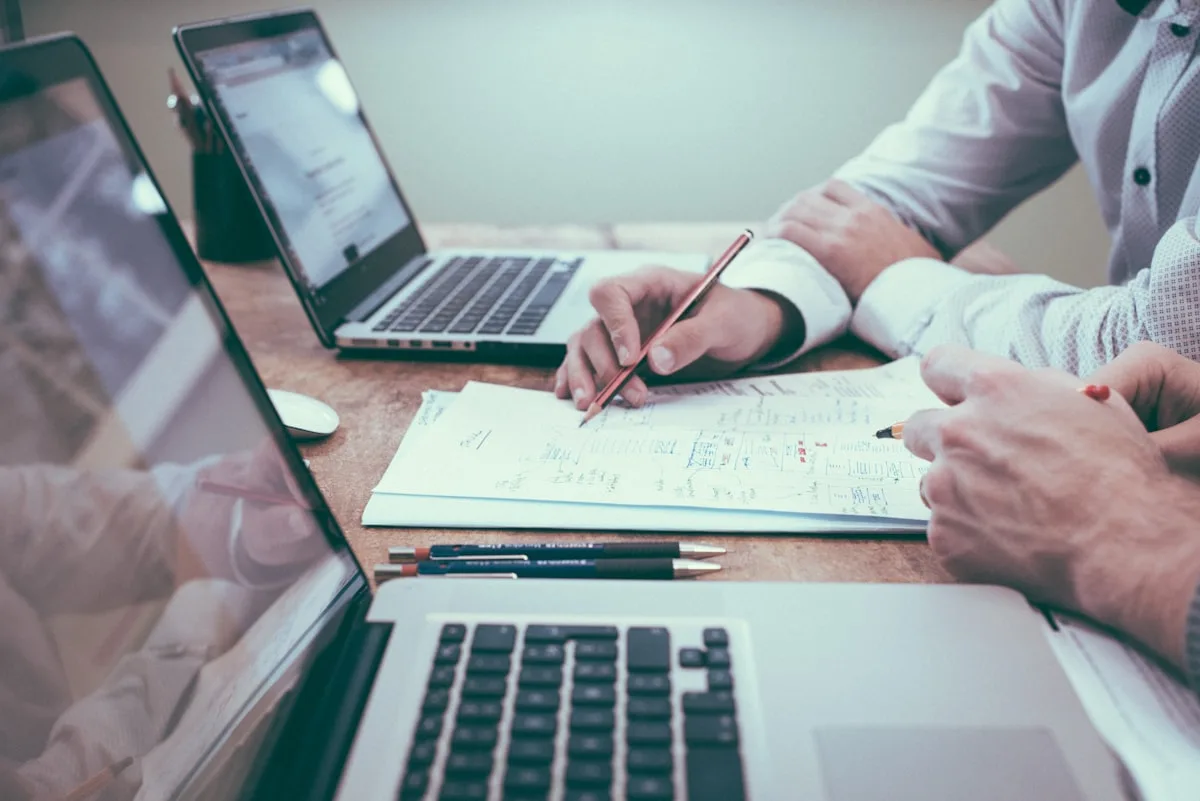 Desk with charts and documents—editorial metaphor for labour-market statistics and payroll reporting, not a Statistics Canada publication or infographic