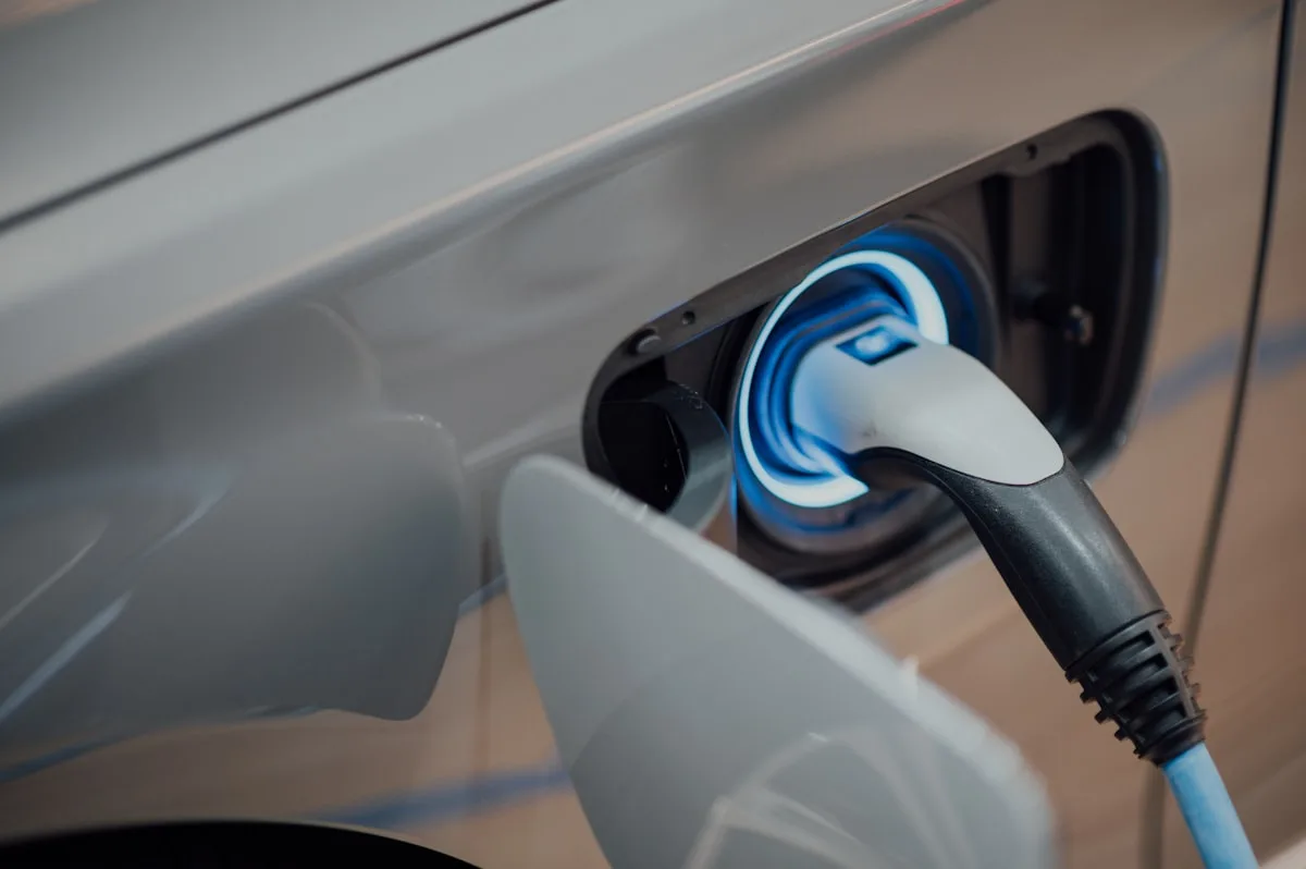 Electric vehicle charging at dusk—illustrative imagery for Newsorga’s lifecycle comparison of electric and gasoline cars.