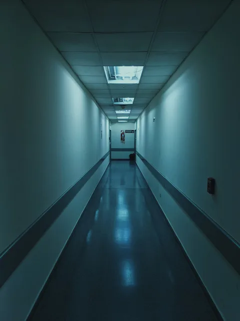 Empty white hospital corridor with overhead lighting — illustrative imagery for reporting on 'Gaza: Doctors Under Attack', the Basement Films documentary about Palestinian medics that the BBC dropped in June 2025, Channel 4 aired in July 2025, and which won the BAFTA TV Award for Current Affairs at London's Royal Festival Hall on Sunday, May 10, 2026.