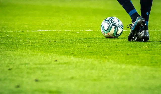 Close-up of a Premier League match ball on grass—illustrative imagery for Newsorga’s feature on Thomas Frank, Ange Postecoglou, and Tottenham Hotspur; not club-branded match photography from a specific fixture.