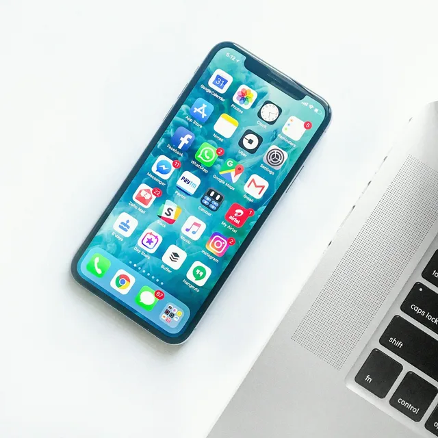 Smartphones on a desk, illustrative file photo for handset industry and sales coverage (Unsplash; not an Apple product photo).