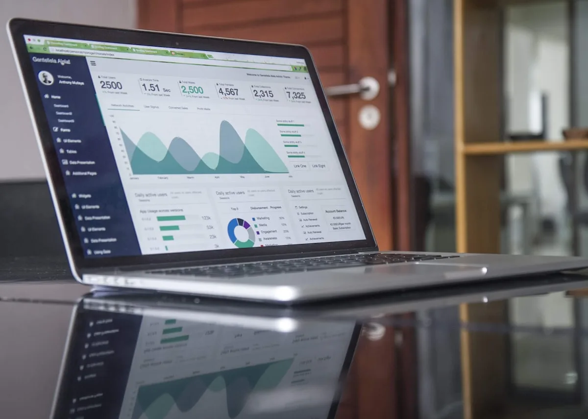 Laptop screen showing charts and analytics—illustrative imagery for Newsorga’s essay on when “AI-first” government or enterprise work speeds paperwork more than it resolves contested decisions.